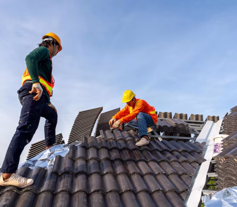 2-construction-workers-install-new-roof-construction-site-electric-drill-used-new-roofs-with-concrete-roof-tiles-concept-residential-building-construction_61243-1559
